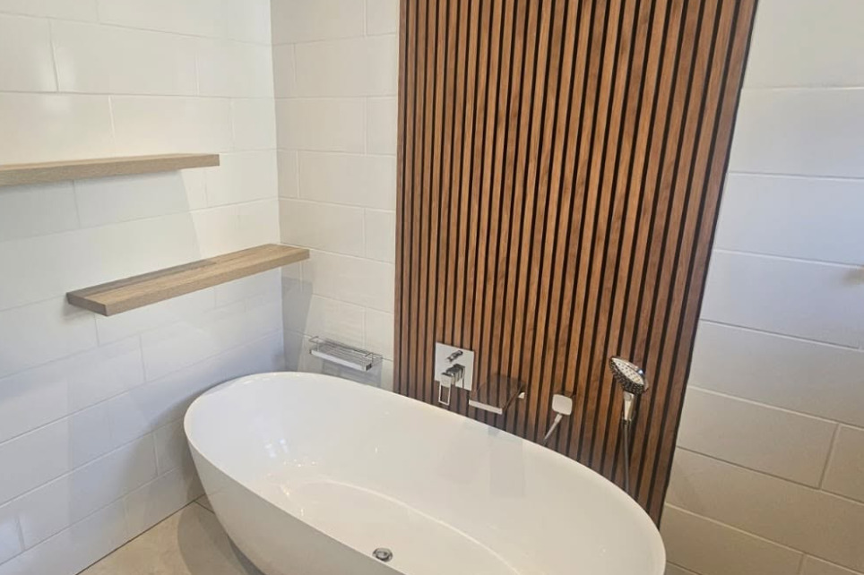 Freestanding bath and timber slat feature wall in a completed Nexus bathroom renovation
